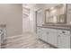 Modern bathroom with walk-in shower and gray tile at 17330 W Royal Palm Rd, Waddell, AZ 85355