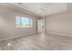 Spacious bedroom with wood-look floors and large window at 17330 W Royal Palm Rd, Waddell, AZ 85355