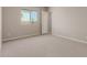 Bright bedroom with neutral carpeting and large window at 17330 W Royal Palm Rd, Waddell, AZ 85355