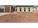 Tan three-bedroom house with a two-car garage and arched windows at 17330 W Royal Palm Rd, Waddell, AZ 85355