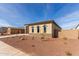 New construction home with a two-car garage and desert landscaping at 17330 W Royal Palm Rd, Waddell, AZ 85355