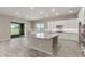 Modern kitchen with island, white cabinets, and stainless steel appliances at 17330 W Royal Palm Rd, Waddell, AZ 85355