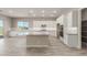 Modern kitchen with island, white cabinets, and stainless steel appliances at 17330 W Royal Palm Rd, Waddell, AZ 85355