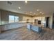 Modern kitchen with white cabinets, grey island, and wood-look tile floors at 17330 W Royal Palm Rd, Waddell, AZ 85355