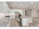 Modern kitchen with island, white cabinets, and stainless steel appliances at 17330 W Royal Palm Rd, Waddell, AZ 85355