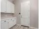 Laundry room with white cabinets and countertop at 17330 W Royal Palm Rd, Waddell, AZ 85355