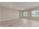 Spacious living room with wood-look tile flooring and lots of natural light at 17330 W Royal Palm Rd, Waddell, AZ 85355