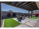 Covered patio with seating area and artificial turf at 18147 W Sandy Rd, Goodyear, AZ 85338