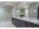 Elegant bathroom with double vanity and patterned shower at 18147 W Sandy Rd, Goodyear, AZ 85338