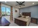 Bright bedroom with a wooden bed frame and window at 18147 W Sandy Rd, Goodyear, AZ 85338