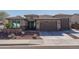 Single-story home with a two-car garage and desert landscaping at 18147 W Sandy Rd, Goodyear, AZ 85338