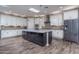 Modern kitchen with large island, granite countertops, and ample cabinet space at 18147 W Sandy Rd, Goodyear, AZ 85338