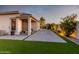 Spacious backyard featuring a paved patio, artificial turf, and mature plants at 18280 N Piccolo Dr, Maricopa, AZ 85138