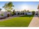 Backyard oasis with artificial turf, a hammock, and neatly landscaped plants at 18280 N Piccolo Dr, Maricopa, AZ 85138