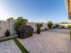 Neatly landscaped backyard with artificial turf, a patio, and a grill at 18280 N Piccolo Dr, Maricopa, AZ 85138