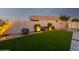 Landscaped backyard with artificial turf, pavers, and a storage shed at 18280 N Piccolo Dr, Maricopa, AZ 85138