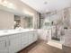 Elegant bathroom with double vanity, large shower, and marble tile at 18280 N Piccolo Dr, Maricopa, AZ 85138