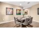 Dining area with square table, gray chairs, and unique artwork at 18280 N Piccolo Dr, Maricopa, AZ 85138