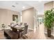 Modern dining room with square table, gray chairs, and views to living area at 18280 N Piccolo Dr, Maricopa, AZ 85138