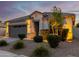 One-story home with gray garage door, landscaping, and a welcoming front porch at 18280 N Piccolo Dr, Maricopa, AZ 85138