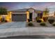 One-story home with gray garage door, landscaping, and a welcoming front porch at 18280 N Piccolo Dr, Maricopa, AZ 85138