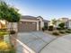 One-story home with gray garage door, landscaping, and a welcoming front porch at 18280 N Piccolo Dr, Maricopa, AZ 85138