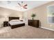 Spacious main bedroom with carpeted floors and ceiling fan at 18280 N Piccolo Dr, Maricopa, AZ 85138