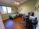 Well-lit bedroom featuring hardwood floors and a built-in workspace at 1878 E Oasis Dr, Tempe, AZ 85283