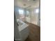 Bathroom with a frameless shower, modern vanity, and tile floor at 19009 W Maryland Ave, Waddell, AZ 85355