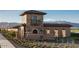 Elegant community entrance with stone architecture and mountain views at 19009 W Maryland Ave, Waddell, AZ 85355