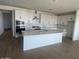 Modern kitchen featuring white cabinetry, quartz countertops, and large island at 19009 W Maryland Ave, Waddell, AZ 85355