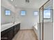 Bathroom with dark vanity, tile flooring, and a soaking tub at 19339 W Valle Vista Way, Litchfield Park, AZ 85340