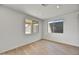 Bright bedroom with wood-look tile flooring and backyard view at 19339 W Valle Vista Way, Litchfield Park, AZ 85340