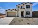 Two-story house with tan exterior, and a two-car garage at 19339 W Valle Vista Way, Litchfield Park, AZ 85340