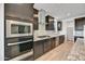 Kitchen with dark cabinetry, granite countertops, and stainless steel appliances at 19339 W Valle Vista Way, Litchfield Park, AZ 85340