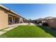 Large backyard with grassy area, patio, and fire pit at 19651 W Monterey Way, Buckeye, AZ 85396