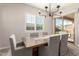 Elegant dining room with a wooden table, six chairs, and a chandelier at 19651 W Monterey Way, Buckeye, AZ 85396