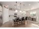 Modern kitchen with white cabinets, granite island, and dining area at 19651 W Monterey Way, Buckeye, AZ 85396