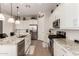 Modern kitchen with granite countertops, stainless steel appliances, and white cabinets at 19651 W Monterey Way, Buckeye, AZ 85396