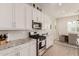 Modern kitchen with white cabinets, granite countertops and stainless steel appliances at 19651 W Monterey Way, Buckeye, AZ 85396