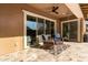 Relaxing covered patio with wicker chairs and tile flooring at 19651 W Monterey Way, Buckeye, AZ 85396