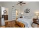 King-size bedroom with hardwood floors and a barn door leading to the bathroom at 20802 N Grayhawk Dr # 1173, Scottsdale, AZ 85255