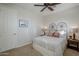 Bright bedroom with ceiling fan, double bed and wooden nightstand at 20802 N Grayhawk Dr # 1173, Scottsdale, AZ 85255