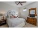 Bedroom with ceiling fan, double bed, dresser and TV at 20802 N Grayhawk Dr # 1173, Scottsdale, AZ 85255