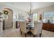 Bright dining room features a round wooden table with seating for six and a chandelier at 20802 N Grayhawk Dr # 1173, Scottsdale, AZ 85255