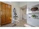 Bright entryway with wood door, tiled floor, and decorative accents at 20802 N Grayhawk Dr # 1173, Scottsdale, AZ 85255