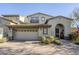 Two-story home with Spanish-style architecture, two-car garage, and landscaped front yard at 20802 N Grayhawk Dr # 1173, Scottsdale, AZ 85255