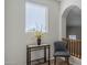 Small hallway with window, chair and decorative table at 20802 N Grayhawk Dr # 1173, Scottsdale, AZ 85255