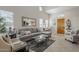 Open living area with gray sectional sofa, glass coffee table and large windows at 20802 N Grayhawk Dr # 1173, Scottsdale, AZ 85255