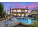 Home's backyard with pool and patio furniture at dusk at 2340 W Myrtle Dr, Chandler, AZ 85248